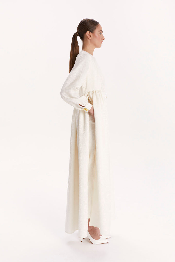 JUMPSUIT WITH A DECORATIVE BELT AND LONG CAPE