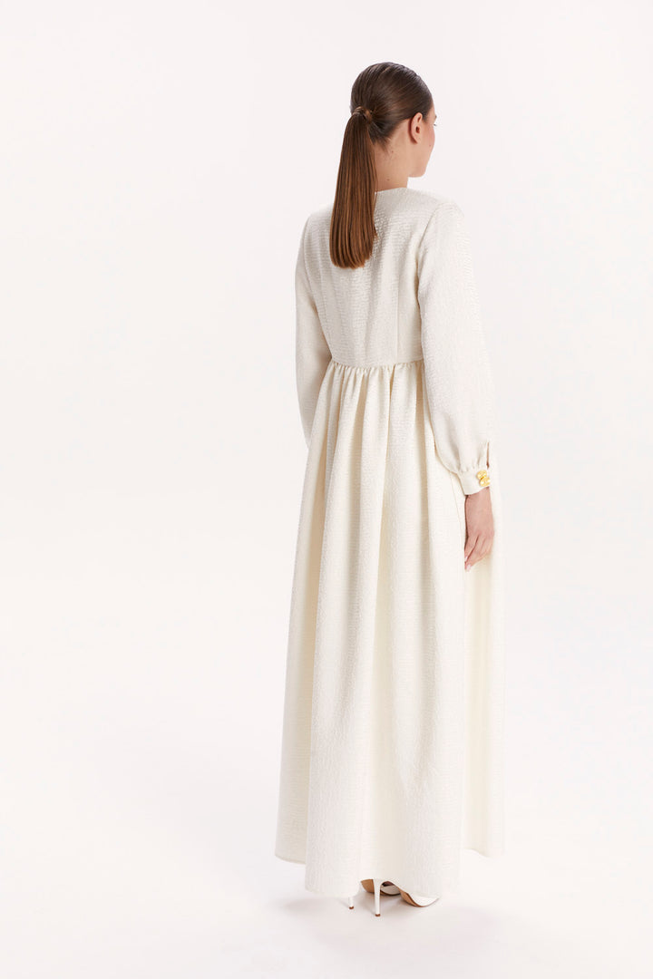 JUMPSUIT WITH A DECORATIVE BELT AND LONG CAPE